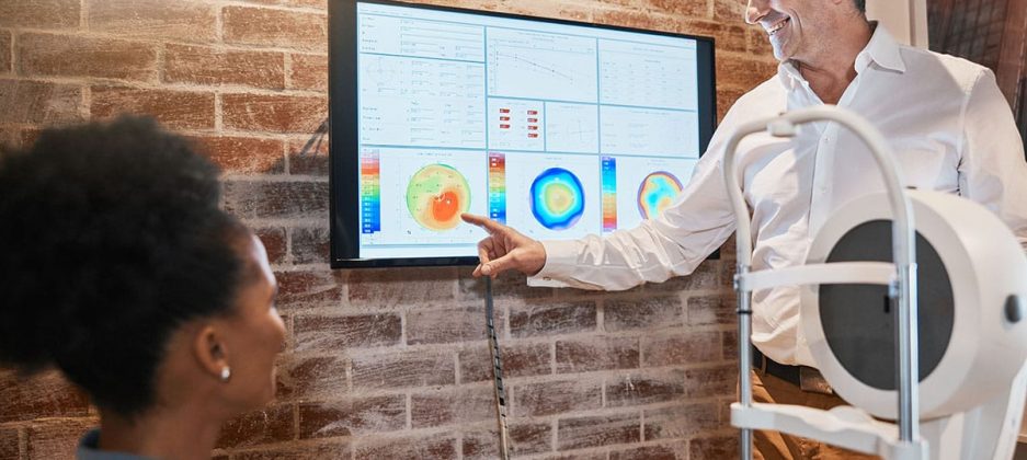 Optometry, technology and optometrist explaining to a patient he Optometry, technology and optometrist explaining to a patient her eye test results in clinic. Healt.